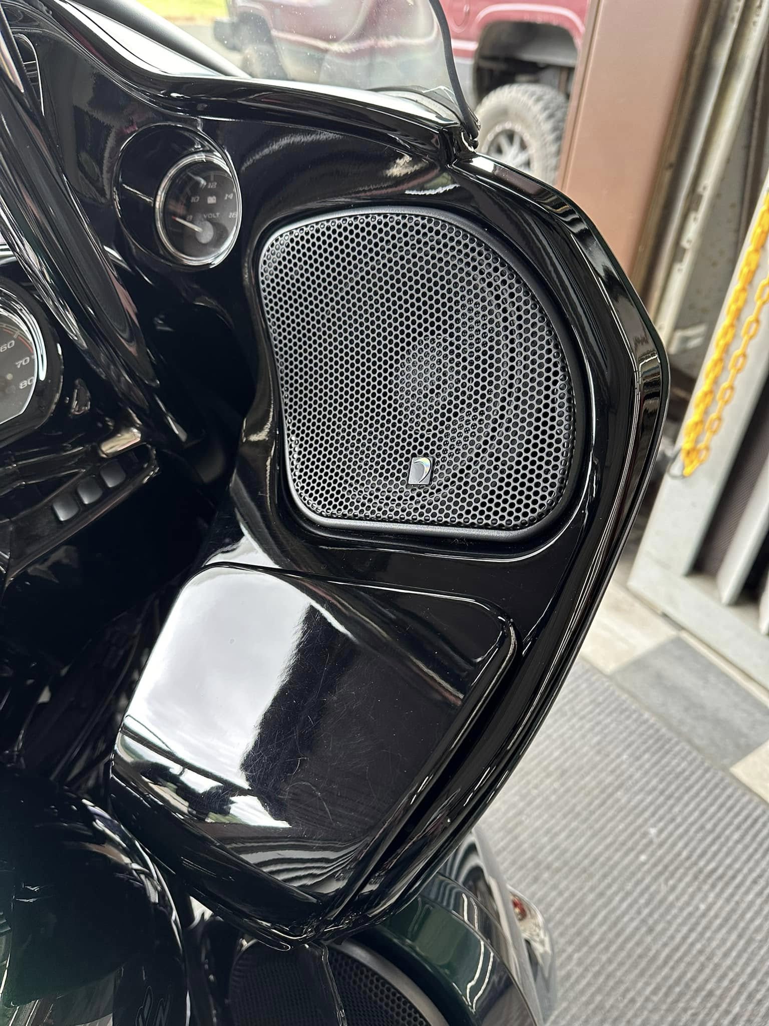 Black motorcycle fairing with oval speaker grille